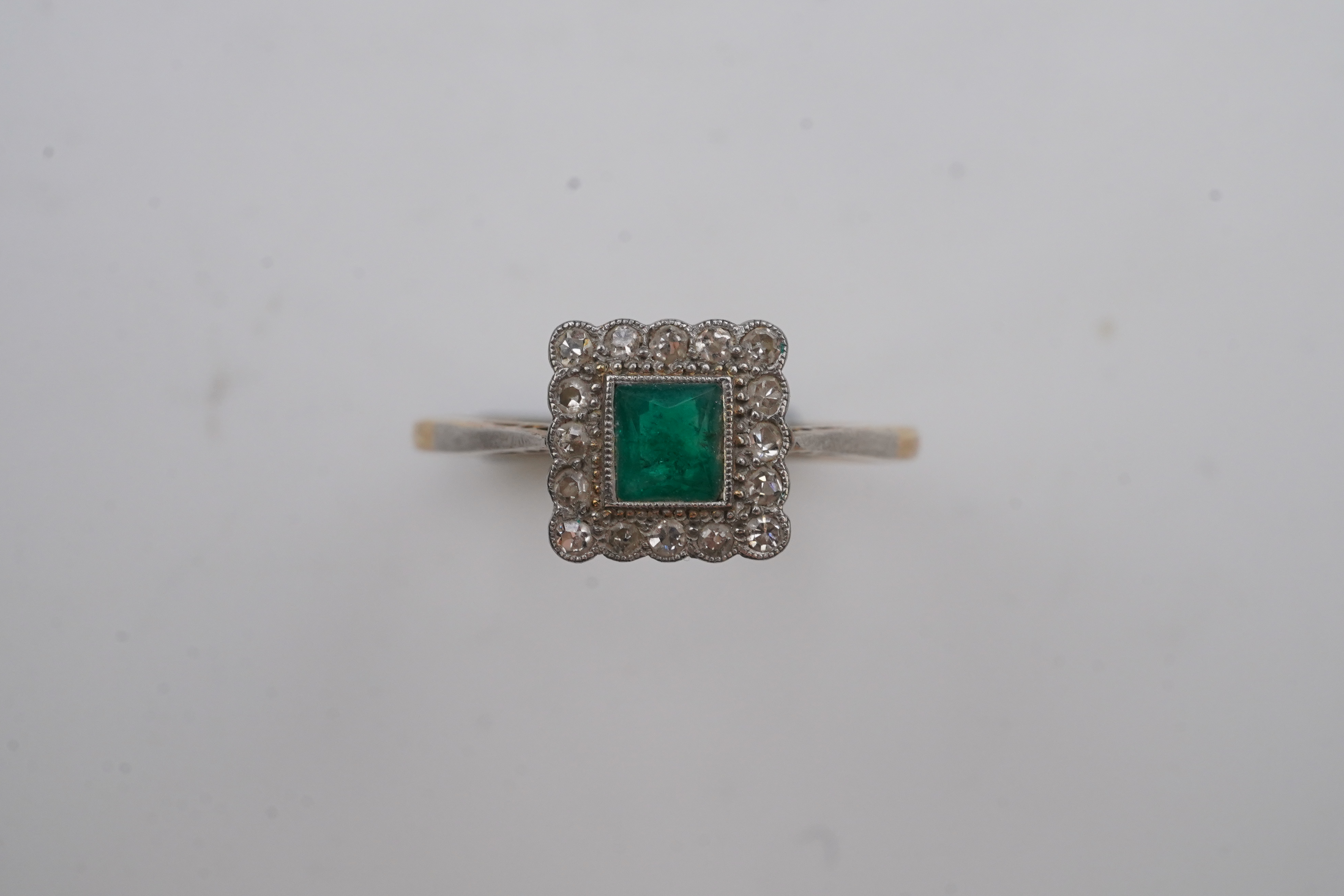 An emerald and diamond ring, early 20th century